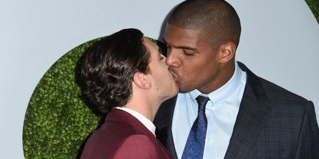 American football player Michael Sam (R) and Vito Cammisano kiss as they arrive for the GQ Men of the Year Party, at Chateau Marmont in West Hollywood, California, on December 4, 2014. AFP PHOTO / ROBYN BECK (Photo credit should read ROBYN BECK/AFP/Getty Images)