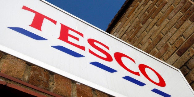 The sign outside a Tesco shop is seen in London, Tuesday, April 21, 2009. Tesco PLC, Britain's largest retailer has reported full-year profits rose 2 percent to 2.17 billion pounds (US$3.15 billion) despite higher than expected losses on its fledgling U.S. venture. (AP Photo/Kirsty Wigglesworth)