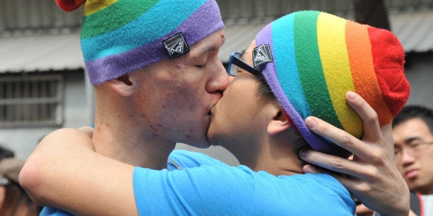 A same-sex couples kiss during an event outside the Legislative Council in Taipei on March 16, 2014. Dozens of members of th
