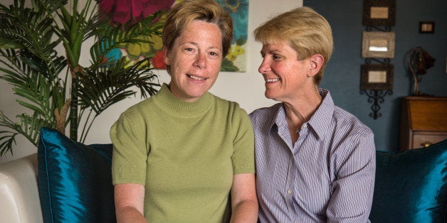 ARLINGTON, VA - JUNE 12: Tammy Smith, Brigadier General in the United States Army Reserve, left, and Tracey Hepner, co-founder of Military Partners and Families Coalition, pose for a portrait at their home in Arlington, Virginia, on Wednesday June 12, 2013. Smith, the first openly gay General in the U.S. Army married her Hepner in the District last year. (Photo by Nikki Kahn/The Washington Post via Getty Images)