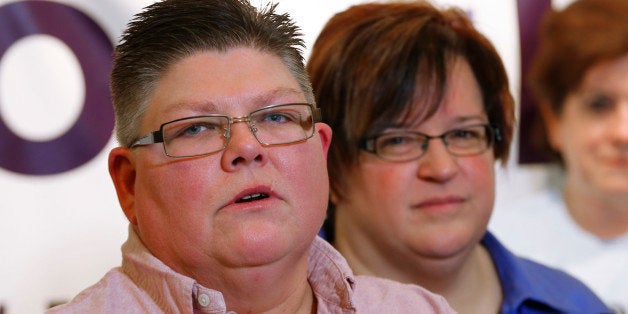 Jayne Rowse, left, and partner April DeBoer of Hazel Park, Mich., look on during a news conference in Ferndale, Mich., Friday, Jan. 16, 2015. Setting the stage for a potentially historic ruling, the Supreme Court said Friday that it will decide whether same-sex couples nationwide have a right to marry under the Constitution. (AP Photo/Paul Sancya)