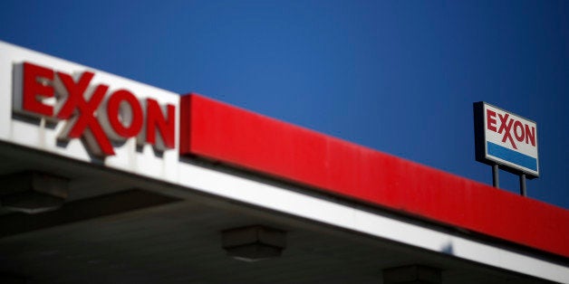 Signage is displayed at an Exxon Mobil Corp. gas station stand Nashville, Tennessee, U.S., on Friday, Jan. 16, 2015. Trips t