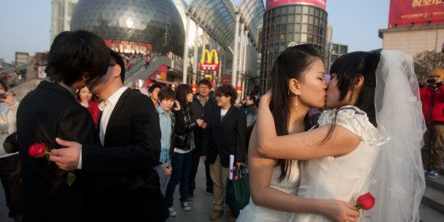 In a picture taken on March 8, 2011 gay couples kiss during their ceremonial 'wedding' as they try to raise awareness of the issue of homosexual marriage, in Wuhan, in central China's Hubei province. Homosexuality was considered a mental disorder in China until 2001. Today, gays face crushing social and family pressure and many remain in the closet as a result, despite gradual steps towards greater acceptance. CHINA OUT AFP PHOTO (Photo credit should read STR/AFP/Getty Images)