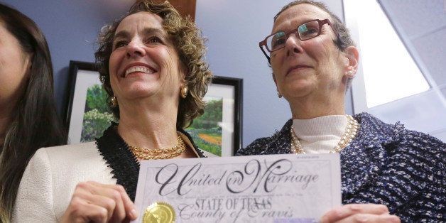 Suzanne Bryant, left, and Sarah Goodfriend, right, pose with their marriage license following a news conference, Thursday, Feb. 19, 2015, in Austin, Texas. Despite Texas' longstanding ban on gay marriage, the same-sex couple married Thursday immediately after being granted a marriage license under a one-time court order issued for medical reasons. (AP Photo/Eric Gay)