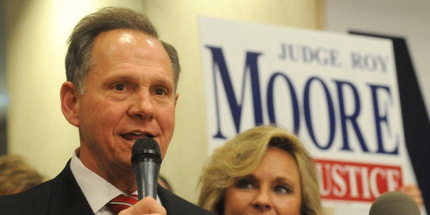 Roy Moore, candidate for Alabama Supreme Court chief justice, speaks to the audience as wife Kayla looks on at his election party in Montgomery, Ala., on election night Tuesday, Nov. 6, 2012. (AP Photo/David Bundy)