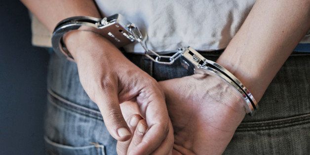 Young man in handcuffs