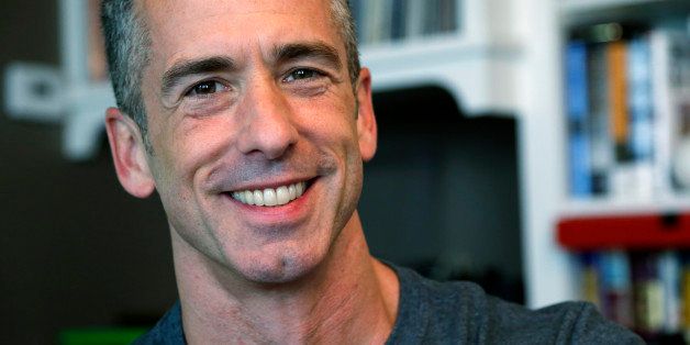 In this photo taken on May 22, 2013, author Dan Savage is in his home in Seattle. Savage's latest book, "American Savage," was released on Tuesday, May 28. (AP Photo/Elaine Thompson)