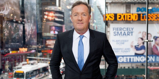 NEW YORK, NY - DECEMBER 08: Piers Morgan visits 'Extra' at their New York studios at H&M in Times Square on December 8, 2014