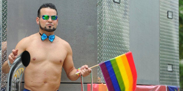 SAN JUAN, PUERTO RICO - JUNE 02: A man dances during the anual gay pride parade on June 02, 2013 in San Juan, Puerto Rico. (Photo by David Gasser/LatinContent/Getty Images)