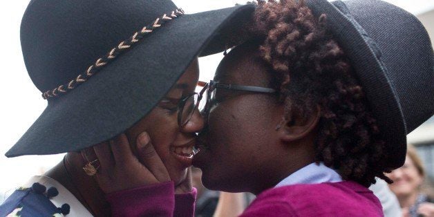 Tori Sisson, left, and Shanté Wolfe, right, kiss after saying their marriage vows, Monday, Feb. 9, 2015, in Montgomery, Ala.