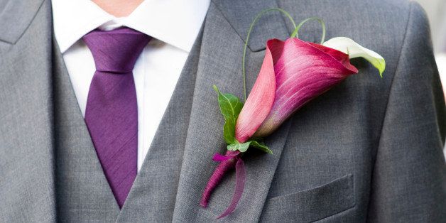 groom wearing a purple lily buttonhole