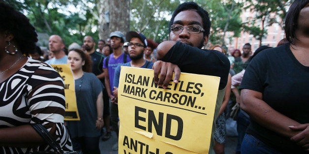 NEW YORK, NY - AUGUST 27: People gather at a vigil for slain transgender woman Islan Nettles at Jackie Robinson Park in Harlem on August 27, 2013 in New York City. Nettles was severely beaten two weeks ago after being approached on the street by a group of men and later died of her injuries. (Photo by Mario Tama/Getty Images)