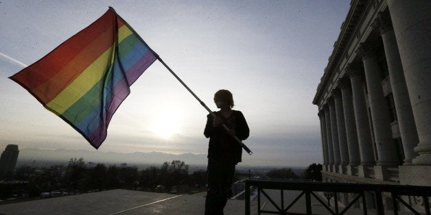 Corbin Aoyagi, a supporters of gay marriage, waves his flag during a rally at the Utah State Capitol, Tuesday, Jan. 28, 2014, in Salt Lake City. Opponents and supporters of gay marriage held twin rallies at the Capitol on Tuesday. More than 1,000 gay couples rushed to get married when a federal judge overturned Utah's constitutional amendment banning same-sex marriage in late December 2013. In early January the U.S. Supreme Court granted Utah's request for an emergency halt to the weddings. (AP Photo/Rick Bowmer)