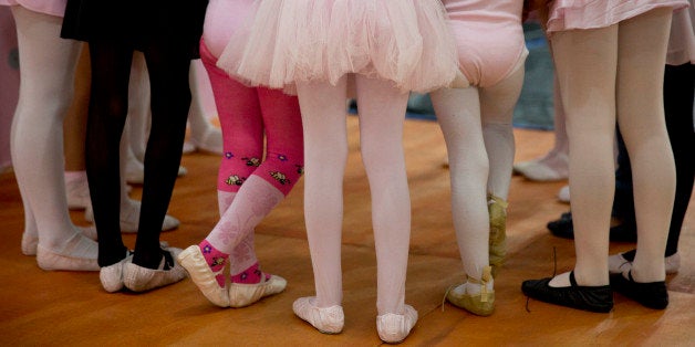 In this Aug. 8, 2014 photo, girls participate in a ballet class at the House of Dreams dance studio in Crackland, one of the roughest neighborhoods in downtown Sao Paulo, Brazil. Twice a week, more than 20 girls, ages 5 through 12, board a Volkswagen van for a 10-minute ride to class, where they put on pink or black tights and ballet shoes donated by a dance wear store. (AP Photo/Andre Penner)