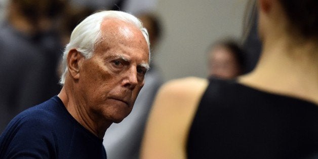 Italian designer Giorgio Armani works backstage before his show at the women Fall / Winter 2015/16 Milan's Fashion Week on March 2, 2015. AFP PHOTO / GABRIEL BOUYS (Photo credit should read GABRIEL BOUYS/AFP/Getty Images)