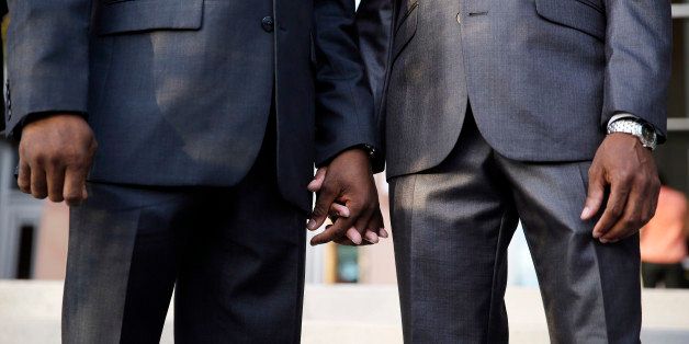 Sherwood Howard, right, and Nevada State Sen. Kelvin Atkinson hold hands before they get married outside of the Marriage License Bureau, Thursday, Oct. 9, 2014, in Las Vegas. The two had just obtained a same-sex marriage license and were the first same-sex couple married in Las Vegas. (AP Photo/John Locher)