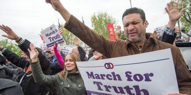 Participants in the March For Marriage pray outside the US Supreme Court on April 25, 2015, in Washington, DC. The Supreme Court meets on April 28 to hear arguments on whether same-sex couples have a constitutional right to wed in the United States, with a final decision expected in June. AFP PHOTO/PAUL J. RICHARDS (Photo credit should read PAUL J. RICHARDS/AFP/Getty Images)