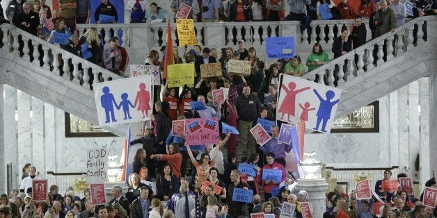 FILE - In this Jan 28, 2014 file photo, people protest during a rally for the opponents for gay marriage at the state Capitol