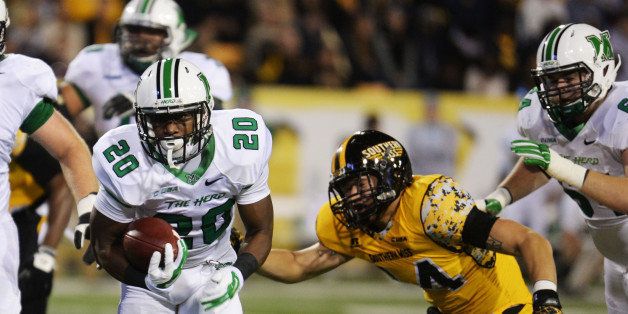 Marshall running back Steward Butler (20) runs past Southern Mississippi linebacker Terrick Wright (14) for a touchdown in the first half of their NCAA college football game in Hattiesburg, Miss., Saturday, Nov. 8, 2014. (AP Photo/Steve Coleman)