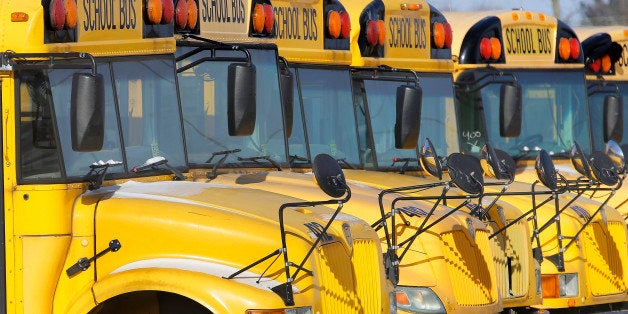 Public school buses are parked unused Wednesday, Jan. 7, 2015, in Springfield, Ill., as schools closed and warming shelters opened in Illinois as bitterly cold temperatures moved into the state. Northern Illinois is experiencing temperatures from -4 to 2 with wind chills as low as 30 degrees below zero. Central and Southern Illinois have avoided snow but is under a wind chill advisory. (AP Photo/Seth Perlman)