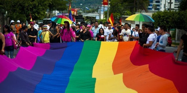 Gay rights activists participate in a demonstration marking the International Day Against Homophobia and Transphobia (IDAHOT) in San Salvador, on May 17, 2014. The 9th annual event, billed by organisers as the biggest LGBT solidarity event in the world, is aimed at raising awareness about discrimation and calling for equal rights. AFP PHOTO / Jose CABEZAS (Photo credit should read JOSE CABEZAS/AFP/Getty Images)