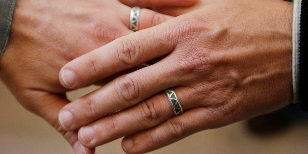 Army Capt. Michael Potoczniak, left, and Todd Saunders, of El Cerrito, Calif., show their wedding rings after they exchanged vows at City Hall in San Francisco, Saturday, June 29, 2013. Dozens of gay couples have lined up outside City Hall in San Francisco as clerks have resumed issuing same-sex marriage licenses one day after a federal appeals court cleared the way for the state of California to immediately lift a 4-year freeze. (AP Photo/Marcio Jose Sanchez)