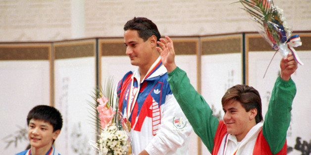 Platform diving gold medal winner Greg Louganis of Boca Raton, Fl., U.S.A. stands on the victory podium during medal awards ceremony at the XXIV Summer Olympic Games in Seoul, South Korea on Sept. 27, 1988. He is flanked by silver medal winner Xiong Ni of China, left, and bronze medal winner Jesus Mena of Mexico. (AP Photo/Ed Reinke)