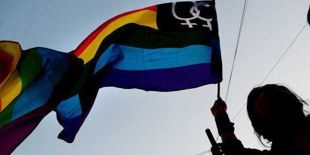 An Indian gay-rights activist waves a rainbow flag during a protest against the Supreme Court ruling reinstating a ban on gay sex, in Kolkata on December 16, 2013. India's Supreme Court reinstated a colonial-era ban on gay sex on that could see homosexuals jailed for up to ten years in a major setback for rights campaigners in the world's biggest democracy. AFP PHOTO/Dibyangshu SARKAR (Photo credit should read DIBYANGSHU SARKAR/AFP/Getty Images)