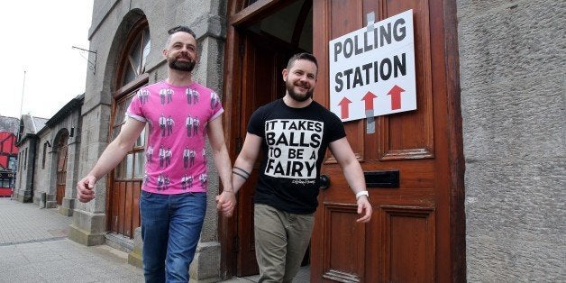 A gay couple pose holding hands as they walk out of a polling station after voting in Drogheda, north Dublin on May 22, 2015. Ireland took to the polls today to vote on whether same-sex marriage should be legal, in a referendum that has exposed sharp divisions between communities in this traditionally Catholic nation. AFP PHOTO / Paul Faith (Photo credit should read PAUL FAITH/AFP/Getty Images)