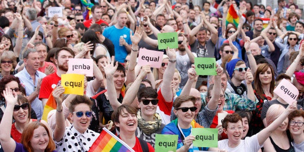 Yes supporters celebrate after as the first results start to filter through in the Irish referendum in Dublin, Ireland, Saturday, May 23, 2015. Ireland has voted resoundingly to legalize gay marriage in the world's first national vote on the issue, leaders on both sides of the Irish referendum declared Saturday even as official ballot counting continued. Senior figures from the "no" campaign, who sought to prevent Ireland's constitution from being amended to permit same-sex marriages, say the only question is how large the "yes" side's margin of victory will be from Friday's vote. (AP Photo/Peter Morrison)