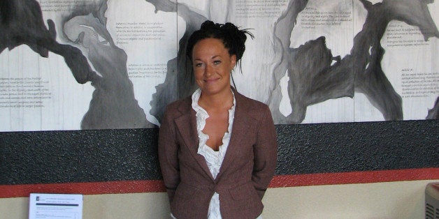 FILE - In this July 24, 2009, file photo, Rachel Dolezal, a leader of the Human Rights Education Institute, stands in front of a mural she painted at the institute's offices in Coeur d'Alene, Idaho. Dolezal, now president of the Spokane, Wash., chapter of the NAACP, is facing questions about whether she lied about her racial identity, with her family saying she is white but has portrayed herself as black. (AP Photo/Nicholas K. Geranios, File)