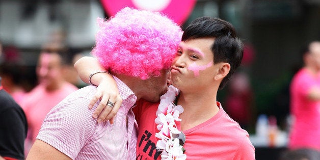 SINGAPORE - JUNE 13: Participants dress in various shades of pink mingle during the 'Pink Dot SG' event at Hong Lim Park on June 13, 2015 in Singapore.Pink Dot SG is Singapore's annual rally to support the Freedom to Love regardless of sexual orientation or gender identity, entering its seventh consecutive year at Hong Lim Park with this year's Ambassadors, Corporate Sponsors, 2015 Campaign Video, and a fresh line-up for the Pink Dot Concert. Singapore has been shrouded in controversy over its approach to same sex relationships with an all out ban on same sex relationships between men. (Photo by Suhaimi Abdullah/Getty Images)