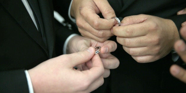 FORT LAUDERDALE, FL - JANUARY 06: A couple exchange rings as they are wed during a wedding ceremony at the Broward County Co