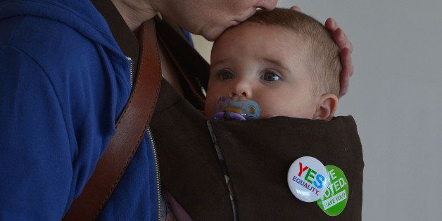 DUBLIN, IRELAND - MAY 23: Belle Horgan aged 7 months old is kissed by her mother Deirdre as the ballot boxes are opened at the RDS count centre on May 23, 2015 in Dublin, Ireland. Voters in the Republic of Ireland are taking part in a referendum on legalising same-sex marriage on Friday. The referendum was held 22 years after Ireland decriminalised homosexuality with more than 3.2m people being asked whether they want to amend the country's constitution to allow gay and lesbian couples to marry. (Photo by Charles McQuillan/Getty Images)