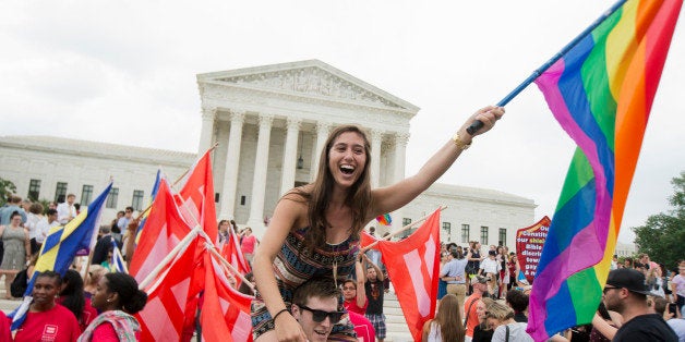 Sasha Altschuler of San Diego, Calif., joins the celebrations outside the Supreme Court in Washington, Friday, June 26, 2015 after the court declared that same-sex couples have a right to marry anywhere in the US. (AP Photo/Manuel Balce Ceneta)