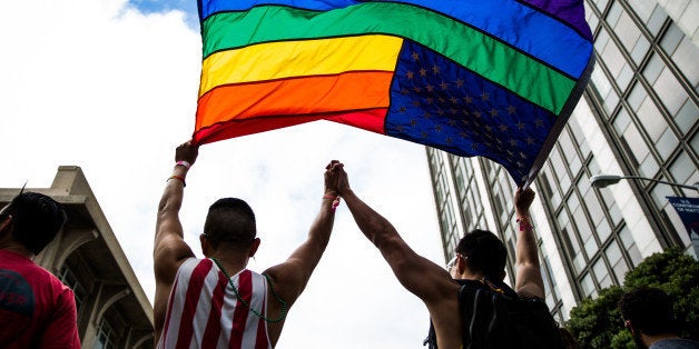 SAN FRANCISCO, CA- JUNE 28: Paulo Torres, left, dances with his husband, Victor Tsang, right, after the San Francisco Gay Pride Parade, June 28, 2015 in San Francisco, California. (Photo by Max Whittaker/Getty Images)