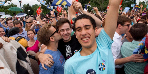 Supporters of same-sex marriage celebrate outside of the Supreme Court in Washington, Friday June 26, 2015, after the court declared that same-sex couples have a right to marry anywhere in the US. (AP Photo/Jacquelyn Martin)