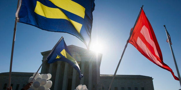 Equality flags fly in front of the Supreme Court in Washington, Tuesday, April 28, 2015. The Supreme Court is set to hear historic arguments in cases that could make same-sex marriage the law of the land. The justices are meeting Tuesday to offer the first public indication of where they stand in the dispute over whether states can continue defining marriage as the union of a man and a woman, or whether the Constitution gives gay and lesbian couples the right to marry. (AP Photo/Cliff Owen)