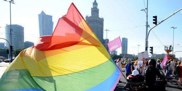 A biker with a multicolor flag attends the annual gay pride parade in Warsaw, Poland, Saturday, June 13, 2015. Gay rights activists hold their 15th yearly "Equality Parade" as Poland slowly grows more accepting of gays and lesbians, but where gay marriage, and even legal partnerships, still appear to be a far-off dream. This year's parade comes amid a right-wing political shift, a possible setback for the LGBT community. (AP Photo/Alik Keplicz)