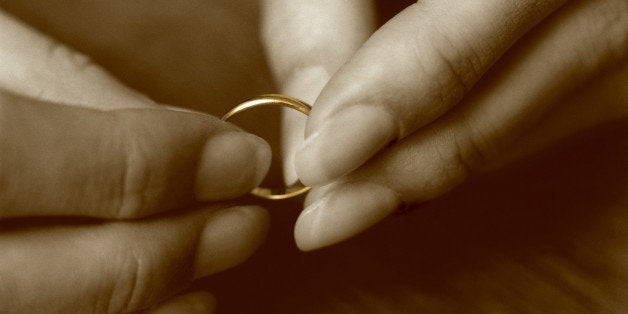 Female hands holding wedding ring