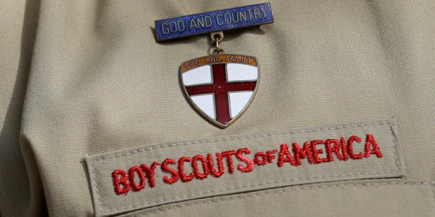 File - In this Feb. 4, 2013 file photo, shows a close up detail of a Boy Scout uniform worn during a news conference in front of the Boy Scouts of America headquarters in Irving, Texas. Attorneys for the Boy Scouts of America have reached a settlement with a former San Antonio Scout who says he was abused by his adult leader. (AP Photo/Tony Gutierrez, File)