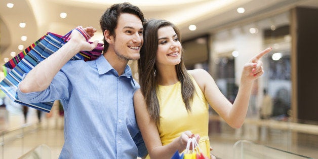 Portrait of happy couple in shopping mall