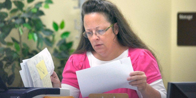 Rowan County Clerk Kim Davis performs her job at the Rowan County Courthouse in Morehead, Ky., Tuesday, Aug. 18, 2015. Davis is back at work and still not issuing marriage licenses while her case is under appeal. U.S. District Judge David Bunning denied Rowan County Clerk Kim Davis' request to delay his ruling from last week ordering her to issue marriage licenses to gay and lesbian couples. That ruling followed the U.S. Supreme Court's decision in June legalizing same-sex marriage nationwide. But Bunning then delayed his own decision, effectively granting Davis' request while also denying it. (AP Photo/Timothy D. Easley)