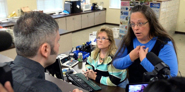 Rowan County Clerk Kim Davis, right, talks with David Moore following her office's refusal to issue marriage licenses at the Rowan County Courthouse in Morehead, Ky., Tuesday, Sept. 1, 2015. Although her appeal to the U.S. Supreme Court was denied, Davis still refuses to issue marriage licenses. (AP Photo/Timothy D. Easley)