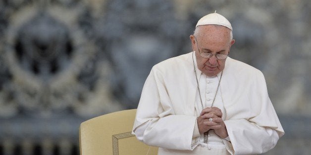 Pope Francis prays during his weekly general audience at St Peter's square on September 30, 2015 at the Vatican. AFP PHOTO / ANDREAS SOLARO (Photo credit should read ANDREAS SOLARO/AFP/Getty Images)