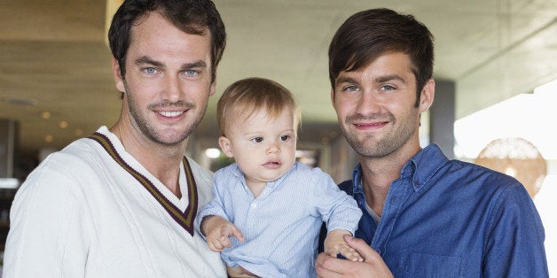 Parents smiling with their son at home