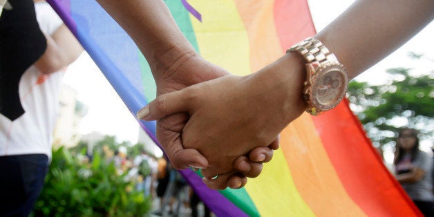 Filipino LGBTs (Lesbians Gays Bisexual and Transgenders) hold hands as they gather for a Gay Pride rally Saturday, June 27, 2