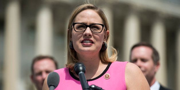 UNITED STATES - MAY 20: Rep. Kyrsten Sinema, D-Ariz., speaks during the bipartisan news conference outside of the Capitol to unveil 'a major proposal aimed at modernizing America's regulatory system to reduce compliance costs, encourage growth and innovation, and improve national competitiveness' on Tuesday, May 20, 2014. (Photo By Bill Clark/CQ Roll Call)