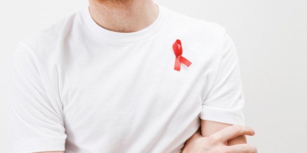 Man wearing aids awareness ribbon