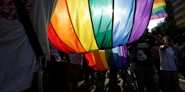 Participants march with a rainbow flag during the Korea Queer Festival in Seoul, South Korea, Sunday, June 28, 2015. Thousands of supporters celebrated the 16th Korea Queer Festival which was held from June 9 to June 28. (AP Photo/Lee Jin-man)